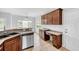 Well-equipped kitchen featuring tile floors, wood cabinetry, and a breakfast bar overlooking backyard at 170 Highwoods Plantation Ave, Summerville, SC 29485