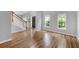 Inviting living room featuring wood floors, staircase, and abundant natural light from large windows at 170 Highwoods Plantation Ave, Summerville, SC 29485