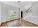 Bright living room with hardwood floors, staircase, and a large window overlooking the front yard at 170 Highwoods Plantation Ave, Summerville, SC 29485