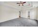 Spacious main bedroom featuring a tray ceiling with a ceiling fan and neutral carpeting at 170 Highwoods Plantation Ave, Summerville, SC 29485