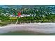 Aerial view of coastal property with beach access and lush landscaping at 1727 Atlantic Ave, Sullivans Island, SC 29482