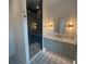 Modern bathroom featuring a glass enclosed shower, decorative tile floors, and contemporary fixtures at 1727 Atlantic Ave, Sullivans Island, SC 29482