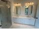 Bathroom featuring double sink vanity with granite countertops and marble floors at 1727 Atlantic Ave, Sullivans Island, SC 29482