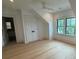 Bright bedroom featuring hardwood floors, a large window, a ceiling fan, and an en suite bathroom at 1727 Atlantic Ave, Sullivans Island, SC 29482