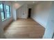 Bright bedroom featuring hardwood floors, a large window, and an en suite bathroom at 1727 Atlantic Ave, Sullivans Island, SC 29482