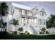 Beautiful two-story home featuring a classic design, inviting front porch, and well-maintained landscaping at 1727 Atlantic Ave, Sullivans Island, SC 29482