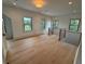 Upstairs landing featuring hardwood floors, natural lighting, and stylish railings overlooking lower levels at 1727 Atlantic Ave, Sullivans Island, SC 29482