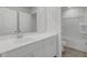 Bright bathroom with double-door linen closet, quartz vanity, and shower-tub combo at 1816 Nola Run, Summerville, SC 29485