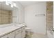 A well-lit bathroom features stone tile accents and modern fixtures at 1872 Montclair Dr # C, Mount Pleasant, SC 29464