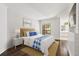Bright bedroom with white walls, wood floors, and a comfortable bed with blue accents at 1872 Montclair Dr # C, Mount Pleasant, SC 29464