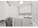 A functional laundry room equipped with a washer, dryer, and storage cabinets at 1872 Montclair Dr # C, Mount Pleasant, SC 29464