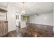 Living room with hardwood floors, views of the kitchen, and door to the private balcony at 1872 Montclair Dr # C, Mount Pleasant, SC 29464