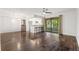 Living room with hardwood floors, ceiling fan, and an open floor plan to dining and kitchen at 1872 Montclair Dr # C, Mount Pleasant, SC 29464
