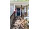 Welcoming front door with a floral wreath, wooden stairs, and fire extinguisher at 19 Rudwick Cir, Goose Creek, SC 29445