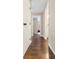 Hallway with views of a bedroom and bathroom features wood-look flooring and white trim at 19 Rudwick Cir, Goose Creek, SC 29445