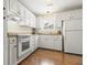 Bright kitchen with white cabinets, appliances, and hardwood floors at 19 Rudwick Cir, Goose Creek, SC 29445