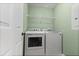 The laundry room features a washer, dryer, and wire shelving for storage at 19 Rudwick Cir, Goose Creek, SC 29445