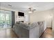 Bright living room with a fireplace, ceiling fan, hardwood floors and access to an outdoor deck at 19 Rudwick Cir, Goose Creek, SC 29445