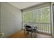 Enclosed porch with table and chairs overlooking a wooded area at 19 Rudwick Cir, Goose Creek, SC 29445