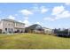 Wide view of large, green, fenced-in backyard featuring grill, outdoor seating, trampoline, and patio at 200 Topsaw Ln, Moncks Corner, SC 29461
