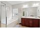 Bright bathroom with a large soaking tub, glass shower, double vanity and neutral paint at 200 Topsaw Ln, Moncks Corner, SC 29461