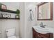 Charming powder room features a decorative mirror, vanity with sink, toilet and decorative shelving at 200 Topsaw Ln, Moncks Corner, SC 29461