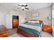 Comfortable bedroom includes a ceiling fan, traditional furnishings, and ensuite bathroom at 200 Topsaw Ln, Moncks Corner, SC 29461