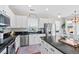 Modern kitchen featuring stainless steel appliances, white cabinets, black countertops, and hardwood floors at 200 Topsaw Ln, Moncks Corner, SC 29461