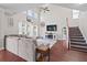 Bright, open living room with vaulted ceilings, large windows, cozy seating, and elegant staircase at 200 Topsaw Ln, Moncks Corner, SC 29461