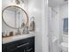 Modern bathroom with granite countertop, round mirror, and tiled shower at 2076 Presidio Dr, Mount Pleasant, SC 29466