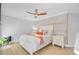Bright bedroom featuring wood accent wall, ceiling fan, and queen size bed at 2076 Presidio Dr, Mount Pleasant, SC 29466