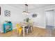 Bright dining room with modern lighting, colorful chairs, and wood-look flooring at 2076 Presidio Dr, Mount Pleasant, SC 29466