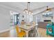 Open dining area leads to the living room and kitchen, featuring vaulted ceilings and modern light fixture at 2076 Presidio Dr, Mount Pleasant, SC 29466
