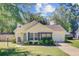 Charming yellow home with landscaped yard, inviting front porch, and attached garage offers great curb appeal at 2076 Presidio Dr, Mount Pleasant, SC 29466