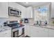 Well-lit kitchen with stainless steel appliances, granite countertops, and white cabinetry at 2076 Presidio Dr, Mount Pleasant, SC 29466