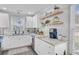 Bright kitchen featuring white cabinets, granite countertops, and decorative floating shelves at 2076 Presidio Dr, Mount Pleasant, SC 29466