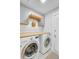 Well-equipped laundry room with washer, dryer, folding rack, and wood countertop at 2076 Presidio Dr, Mount Pleasant, SC 29466