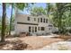 Exterior showcasing the white siding, bay window, patio, and lush backyard at 220 Runnymede Ln, Summerville, SC 29485