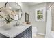 Bright bathroom featuring modern vanity, white countertops, round mirror, and stylish fixtures at 220 Runnymede Ln, Summerville, SC 29485