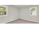 Empty bedroom with neutral walls, carpet flooring, and natural light from two windows at 220 Runnymede Ln, Summerville, SC 29485