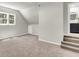Neutral bonus room with carpet, window, and access to a bathroom and attic at 220 Runnymede Ln, Summerville, SC 29485