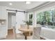Sunny dining area with natural light, barn door, round table, and backyard view from the kitchen at 220 Runnymede Ln, Summerville, SC 29485