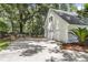 Detached three-car garage with long driveway and lush surroundings at 220 Runnymede Ln, Summerville, SC 29485