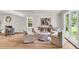 Cozy living room featuring a fireplace, round mirror and comfortable chairs, filled with light at 220 Runnymede Ln, Summerville, SC 29485
