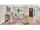 Bright and airy living room with stylish seating, a large window, and a light wood floor at 220 Runnymede Ln, Summerville, SC 29485