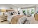 Serene main bedroom with large windows, soft textiles, and a seating area at 220 Runnymede Ln, Summerville, SC 29485