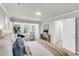 Spacious main bedroom featuring plush textiles, natural light, and a cozy seating area near bathroom entrance at 220 Runnymede Ln, Summerville, SC 29485