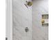Shower with stylish white marble-look tile and a built-in shower niche at 220 Runnymede Ln, Summerville, SC 29485