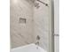 Elegant shower featuring white marble-look tiling and a built-in niche at 220 Runnymede Ln, Summerville, SC 29485