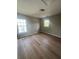 Cozy bedroom featuring hardwood floors and windows that provide plenty of natural light at 308 Tidal Rice Ct, Wando, SC 29492